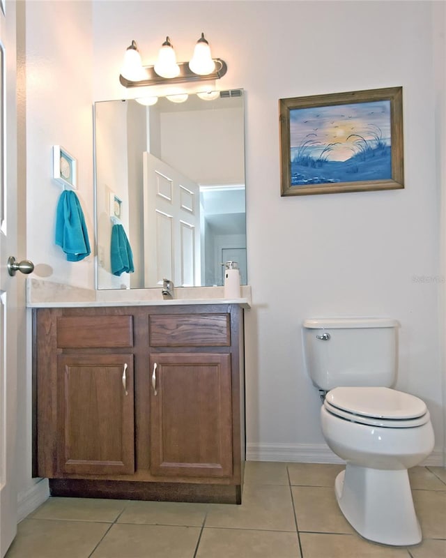 bathroom with vanity, toilet, and tile patterned floors