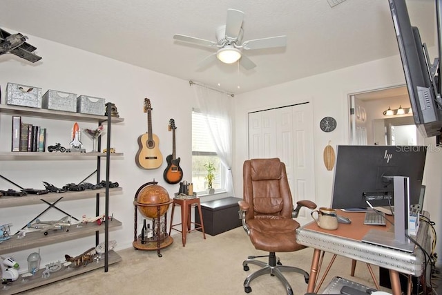 carpeted home office with ceiling fan