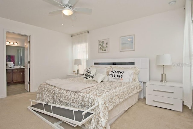 carpeted bedroom featuring ceiling fan and ensuite bathroom