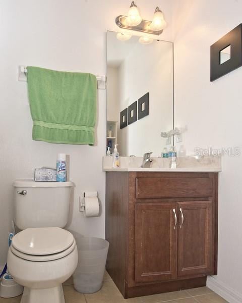 bathroom with vanity, tile patterned flooring, and toilet