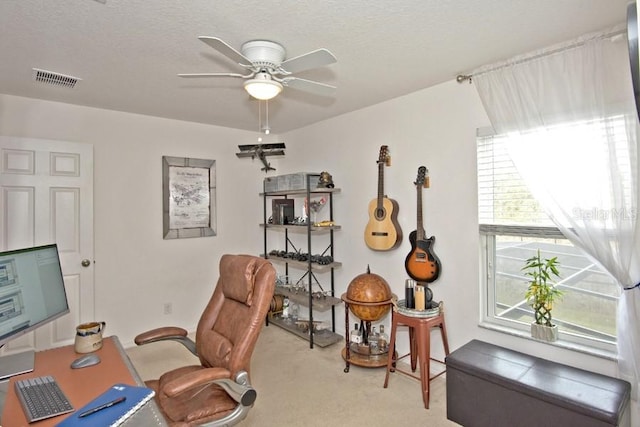 home office with ceiling fan, light colored carpet, and a textured ceiling