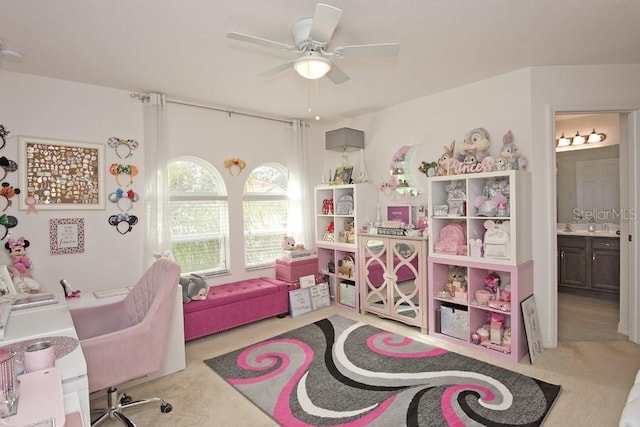 recreation room with light carpet and ceiling fan