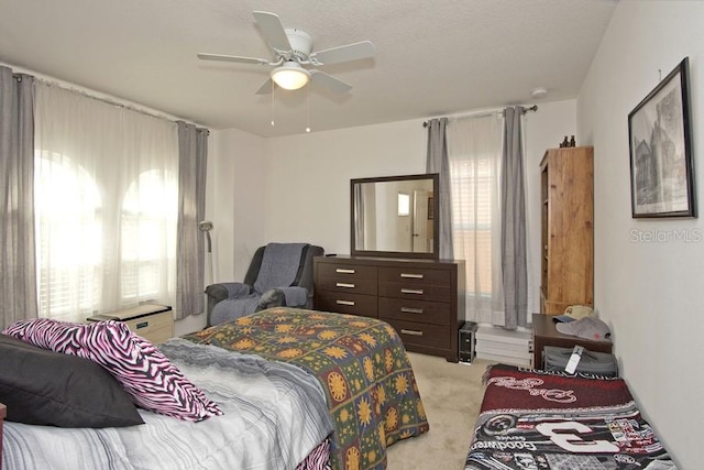 bedroom featuring ceiling fan and light colored carpet