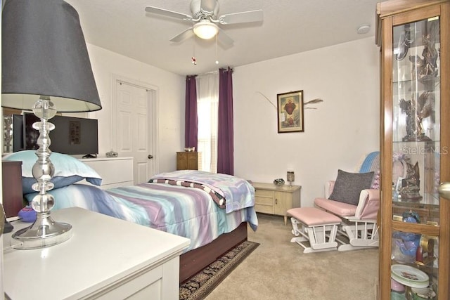 bedroom featuring ceiling fan and light colored carpet