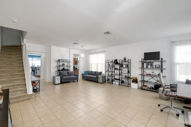436 Orange Cosmos Blvd, Davenport, FL 33837 - living area with light tile patterned flooring, stairway, and healthy amount of natural light