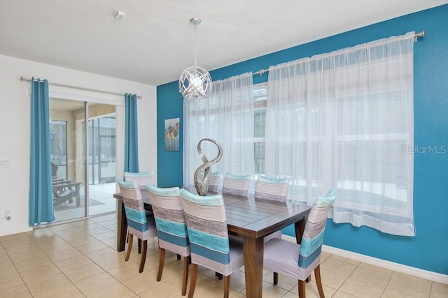 436 Orange Cosmos Blvd, Davenport, FL 33837 - dining room featuring a chandelier, light tile patterned floors, and baseboards