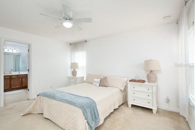 436 Orange Cosmos Blvd, Davenport, FL 33837 - bedroom featuring light colored carpet, ensuite bath, and a ceiling fan
