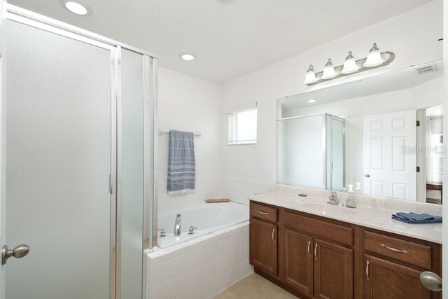 436 Orange Cosmos Blvd, Davenport, FL 33837 - bathroom featuring a shower stall, a garden tub, vanity, and tile patterned floors