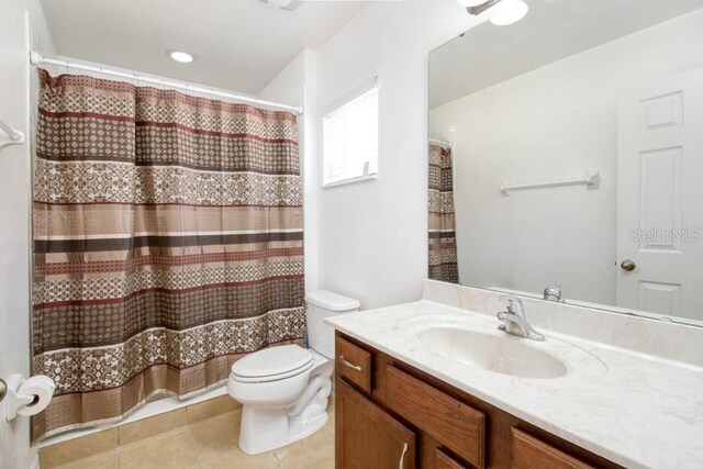 436 Orange Cosmos Blvd, Davenport, FL 33837 - bathroom with toilet, vanity, tile patterned floors, and a shower with curtain