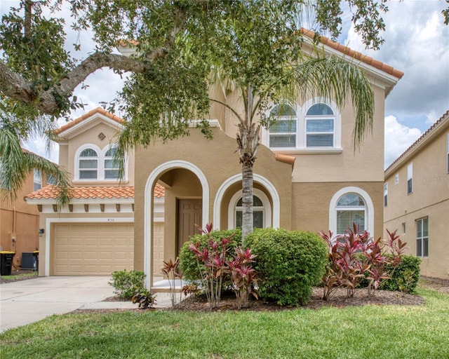 436 Orange Cosmos Blvd, Davenport, FL 33837 - mediterranean / spanish home with an attached garage, driveway, central AC unit, stucco siding, and a tiled roof