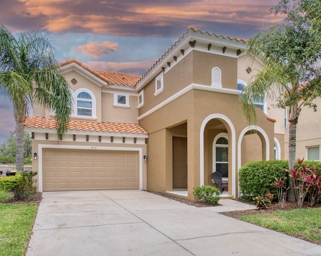 436 Orange Cosmos Blvd, Davenport, FL 33837 - mediterranean / spanish house with stucco siding, an attached garage, a tile roof, and concrete driveway