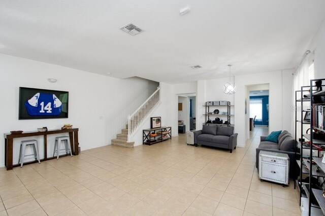 436 Orange Cosmos Blvd, Davenport, FL 33837 - living room featuring stairway and light tile patterned flooring