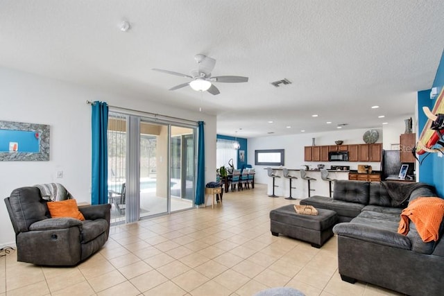 436 Orange Cosmos Blvd, Davenport, FL 33837 - living area featuring ceiling fan, light tile patterned floors, recessed lighting, and a textured ceiling