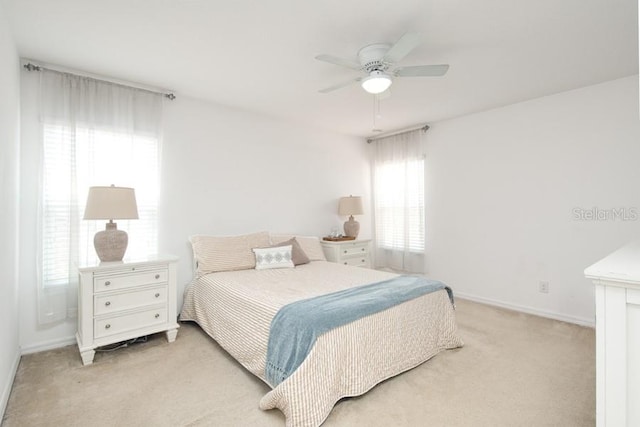 436 Orange Cosmos Blvd, Davenport, FL 33837 - bedroom with light colored carpet, baseboards, and ceiling fan
