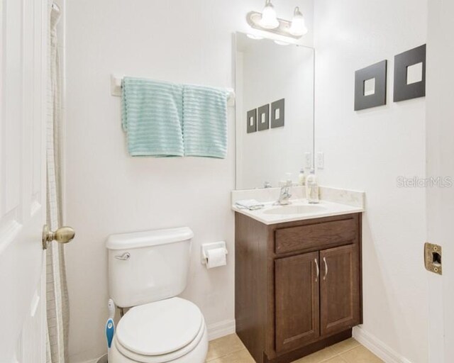 436 Orange Cosmos Blvd, Davenport, FL 33837 - full bath featuring toilet, vanity, baseboards, and tile patterned flooring