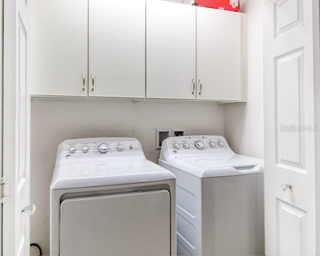 436 Orange Cosmos Blvd, Davenport, FL 33837 - laundry area with cabinet space and washing machine and dryer