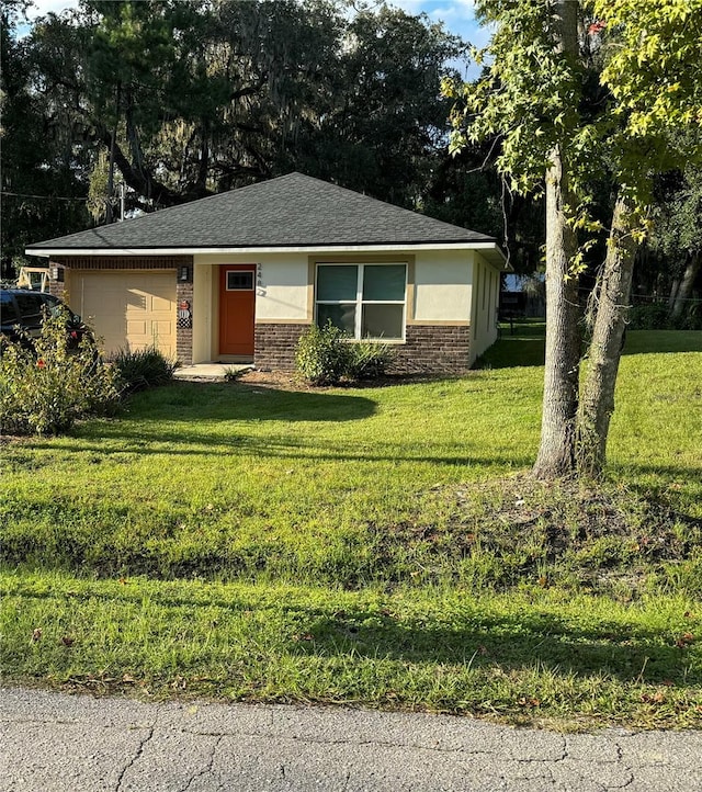 view of front facade featuring a front lawn and a garage