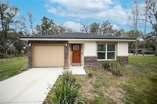 view of front of home featuring a front yard, brick siding, driveway, and an attached garage