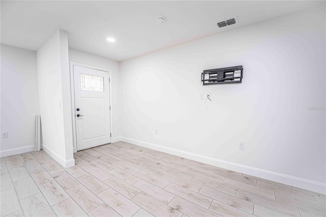 entryway with visible vents, light wood finished floors, and baseboards