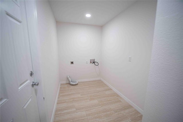 clothes washing area with laundry area, baseboards, hookup for an electric dryer, light wood-type flooring, and recessed lighting