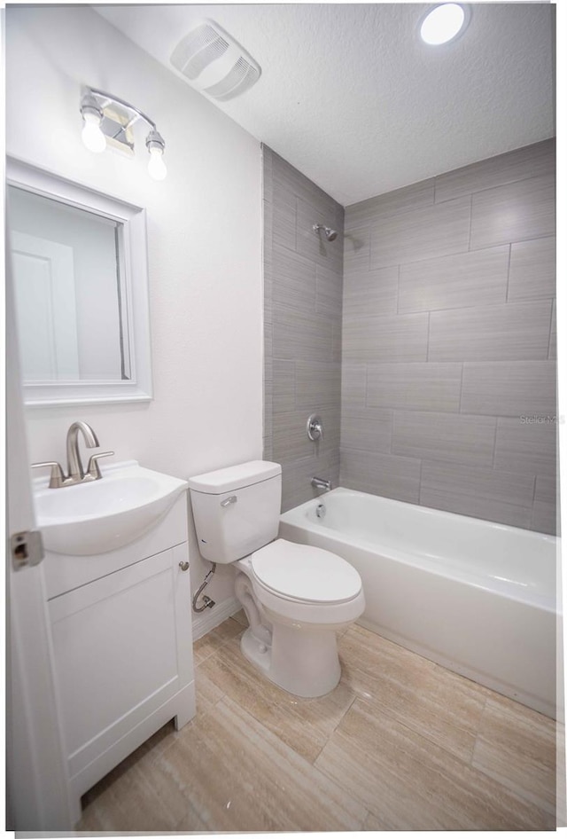 bathroom with visible vents, toilet, tub / shower combination, a textured ceiling, and vanity