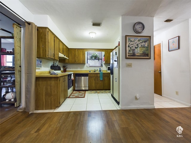 kitchen featuring light hardwood / wood-style flooring and appliances with stainless steel finishes