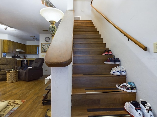 stairs featuring wood-type flooring