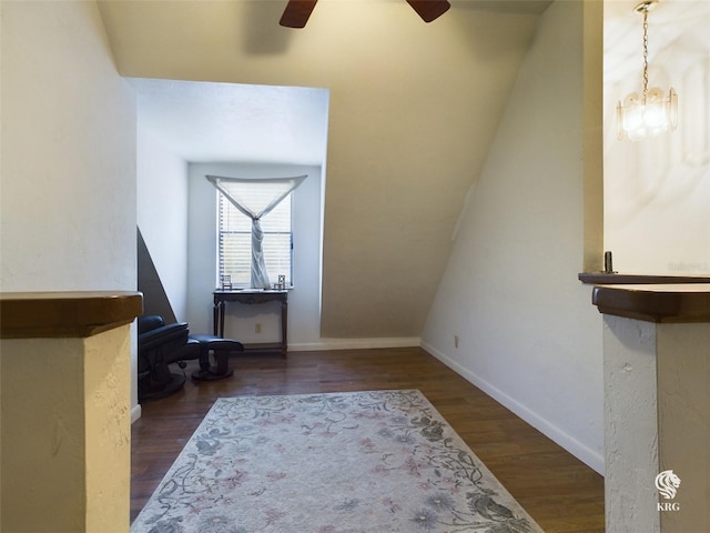 foyer entrance featuring ceiling fan with notable chandelier and dark hardwood / wood-style floors