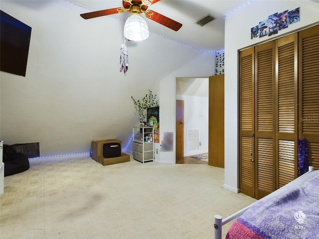 carpeted bedroom featuring lofted ceiling, ceiling fan, and a closet