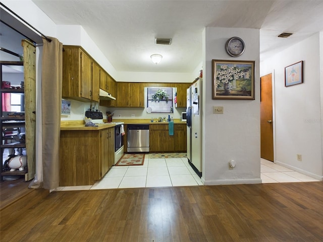 kitchen with sink, white appliances, and light hardwood / wood-style floors