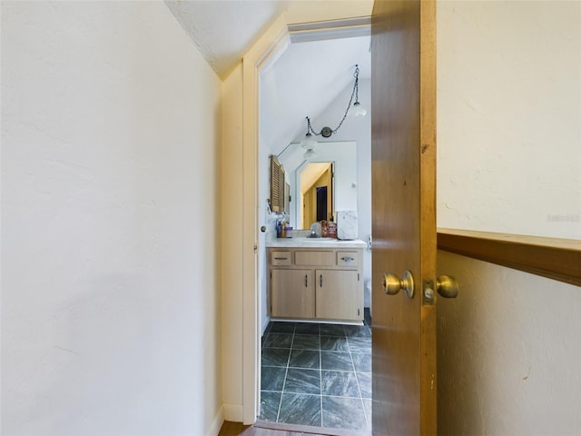 bathroom featuring lofted ceiling and vanity