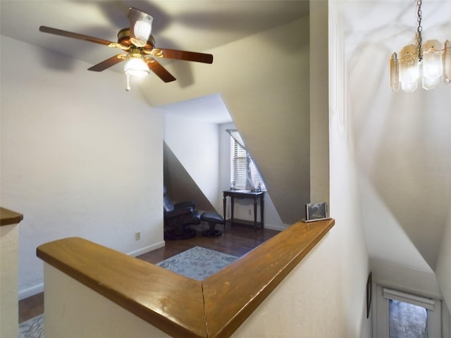 interior space featuring ceiling fan with notable chandelier