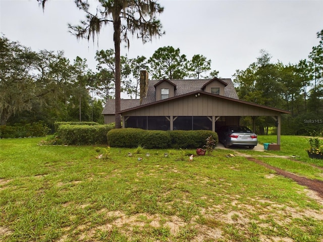 view of side of home featuring a carport and a yard