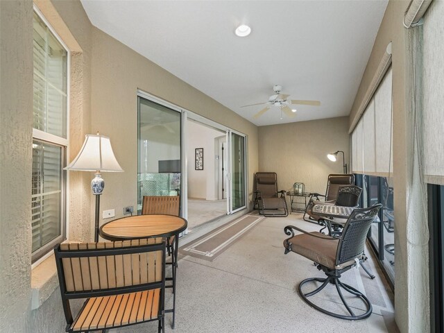 sunroom / solarium featuring ceiling fan