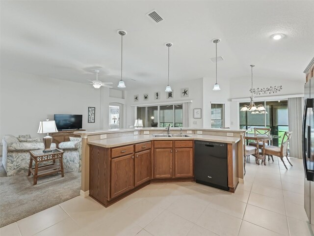 kitchen featuring ceiling fan with notable chandelier, dishwasher, a kitchen island with sink, and sink