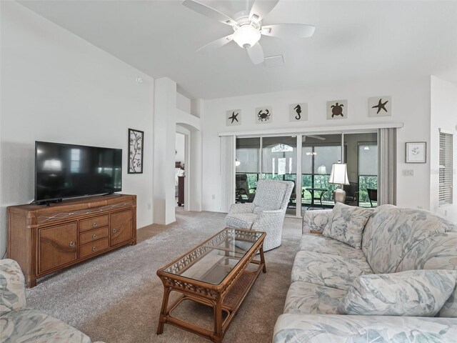 living room with ceiling fan and carpet flooring