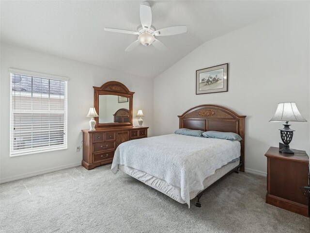 bedroom featuring ceiling fan, lofted ceiling, and light carpet