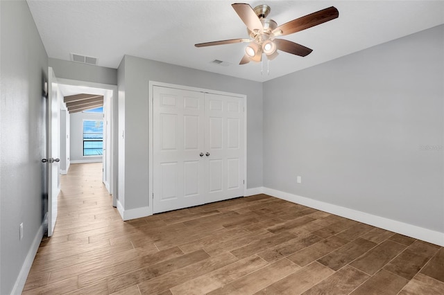 unfurnished bedroom featuring a closet, ceiling fan, and hardwood / wood-style flooring