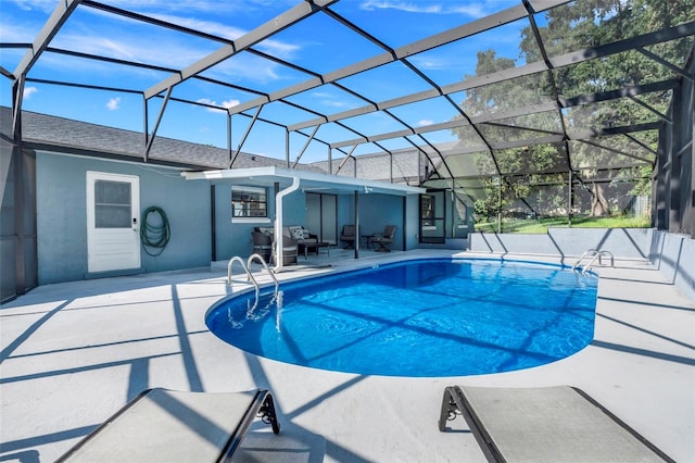 view of pool with glass enclosure and a patio