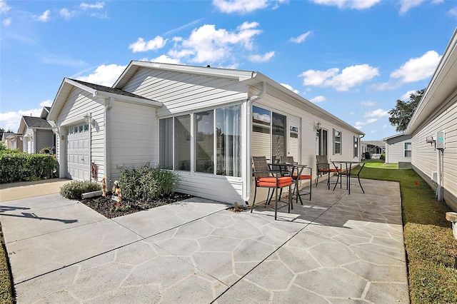 rear view of house featuring a garage