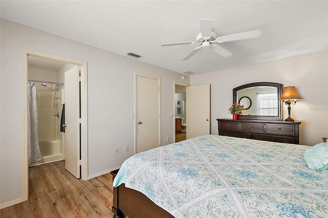 bedroom with ceiling fan, a textured ceiling, and light wood-type flooring