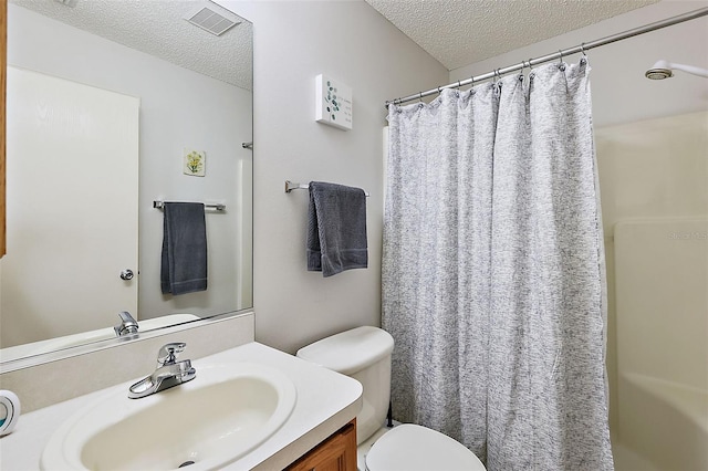 bathroom featuring a textured ceiling, vanity, toilet, and a shower with shower curtain