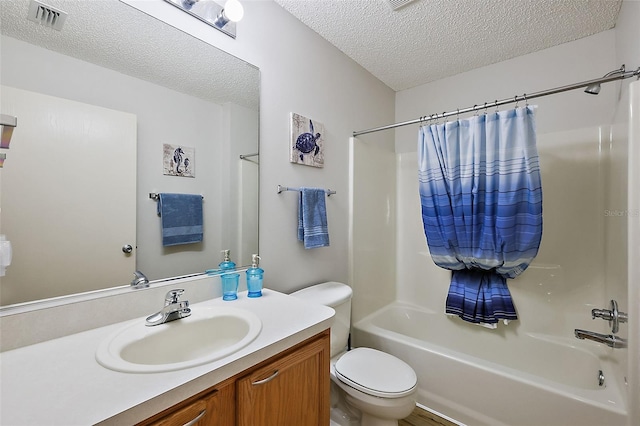 full bathroom featuring vanity, shower / bathtub combination with curtain, toilet, and a textured ceiling