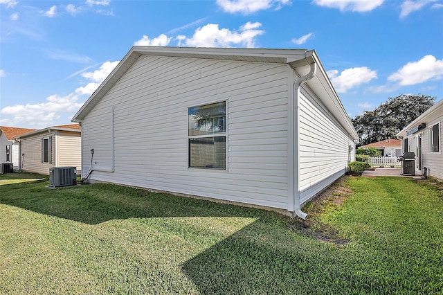 exterior space with a yard and central air condition unit