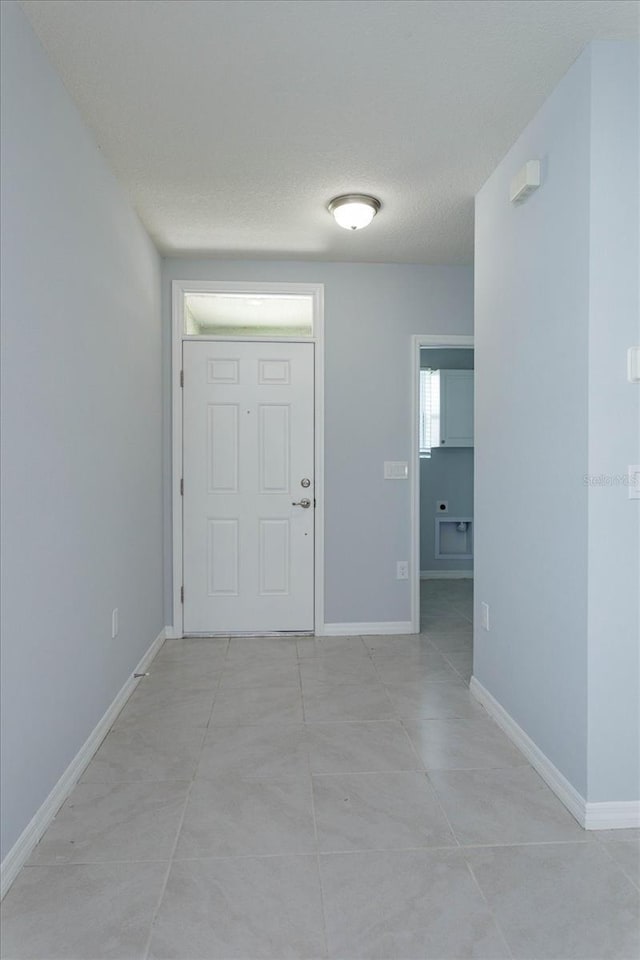 3654 Caspian St, Leesburg, FL 34748 - entryway with baseboards and a textured ceiling