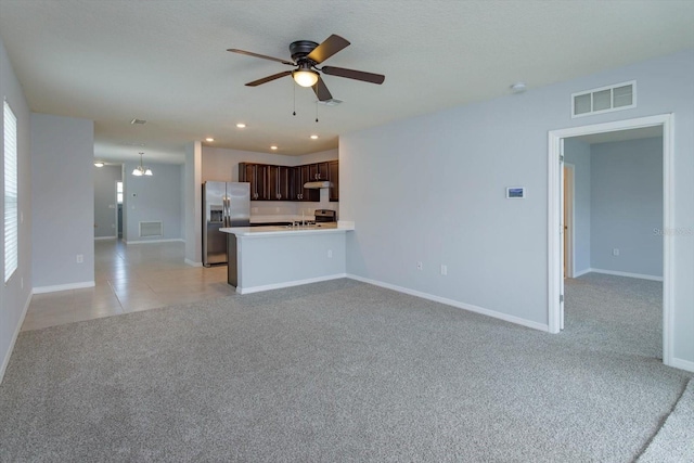 unfurnished living room featuring ceiling fan and light colored carpet