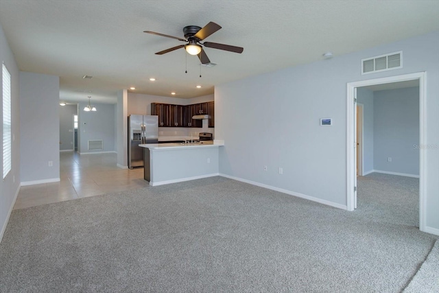 3654 Caspian St, Leesburg, FL 34748 - unfurnished living room with light colored carpet, visible vents, baseboards, and a ceiling fan