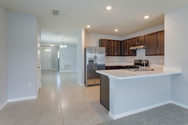 kitchen with dark brown cabinetry, sink, kitchen peninsula, stainless steel appliances, and an inviting chandelier