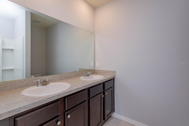 3654 Caspian St, Leesburg, FL 34748 - bathroom featuring baseboards, double vanity, visible vents, and a sink