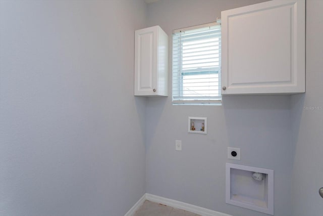 washroom featuring cabinets, hookup for an electric dryer, hookup for a washing machine, and light tile patterned floors